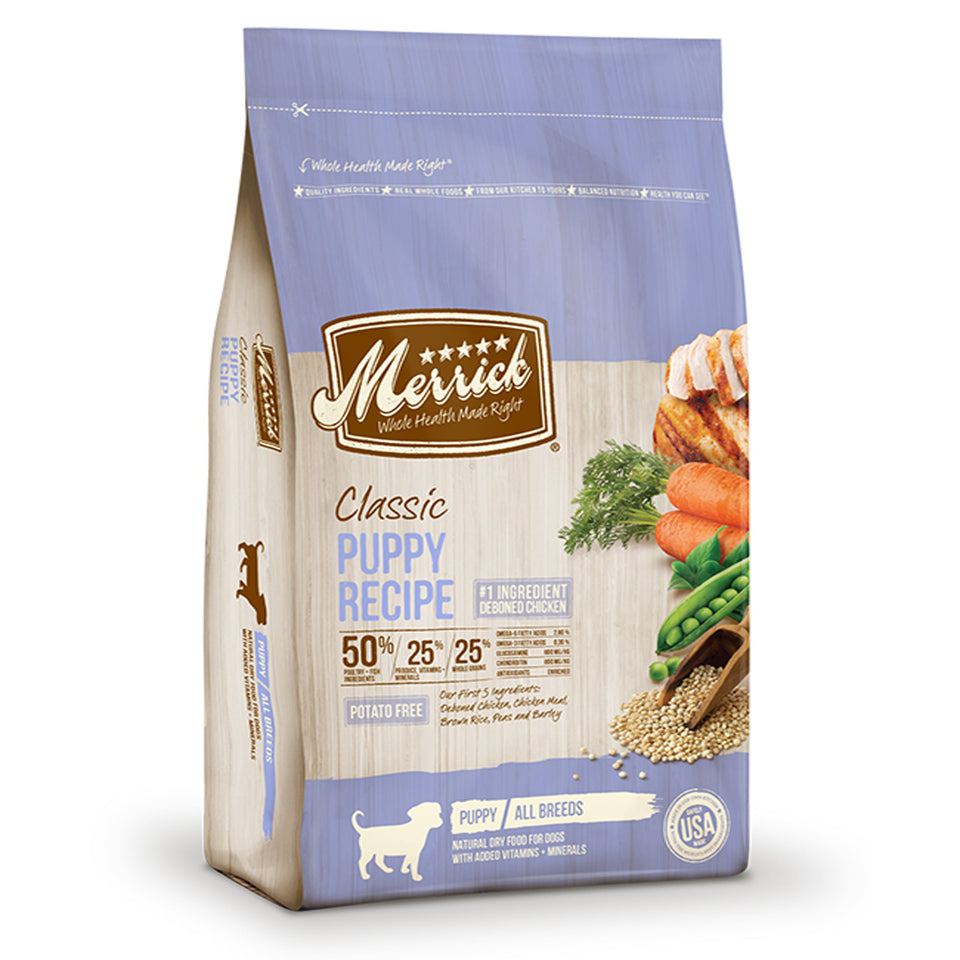 Blue and tan dog food bag with chicken, carrots, and peas graphic