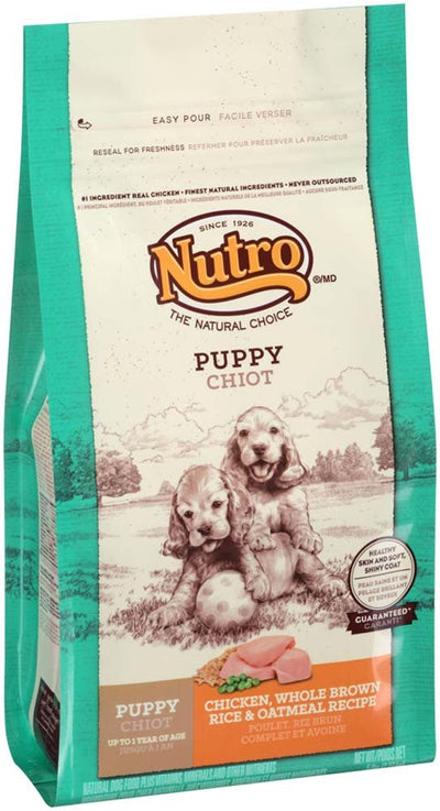 Nutro Natural Choice Puppy food bag, chicken and brown rice recipe, with two cocker spaniel puppies on the front.