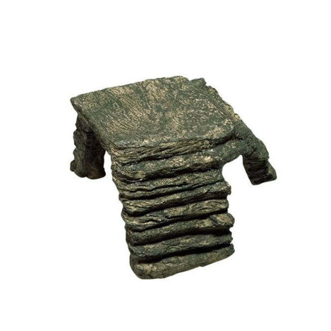 Small, dark green, layered rock basking platform with a corner ramp, viewed from a slightly elevated angle.