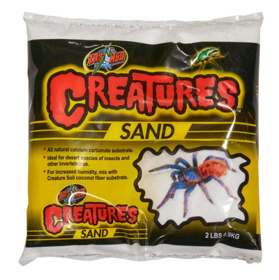 White bag of Zoo Med Creatures Sand with a red and blue tarantula and green beetle on the label.