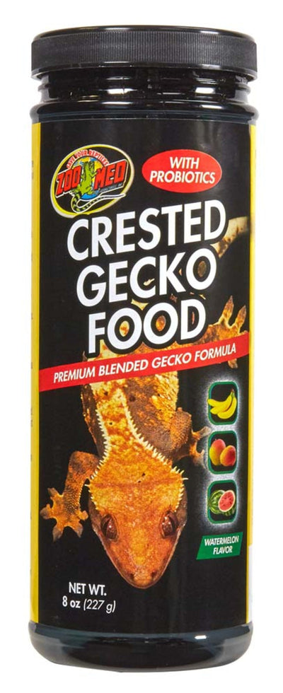 Black jar of Zoo Med Crested Gecko Food with a gecko illustration, "Watermelon Flavor," and fruit icons.