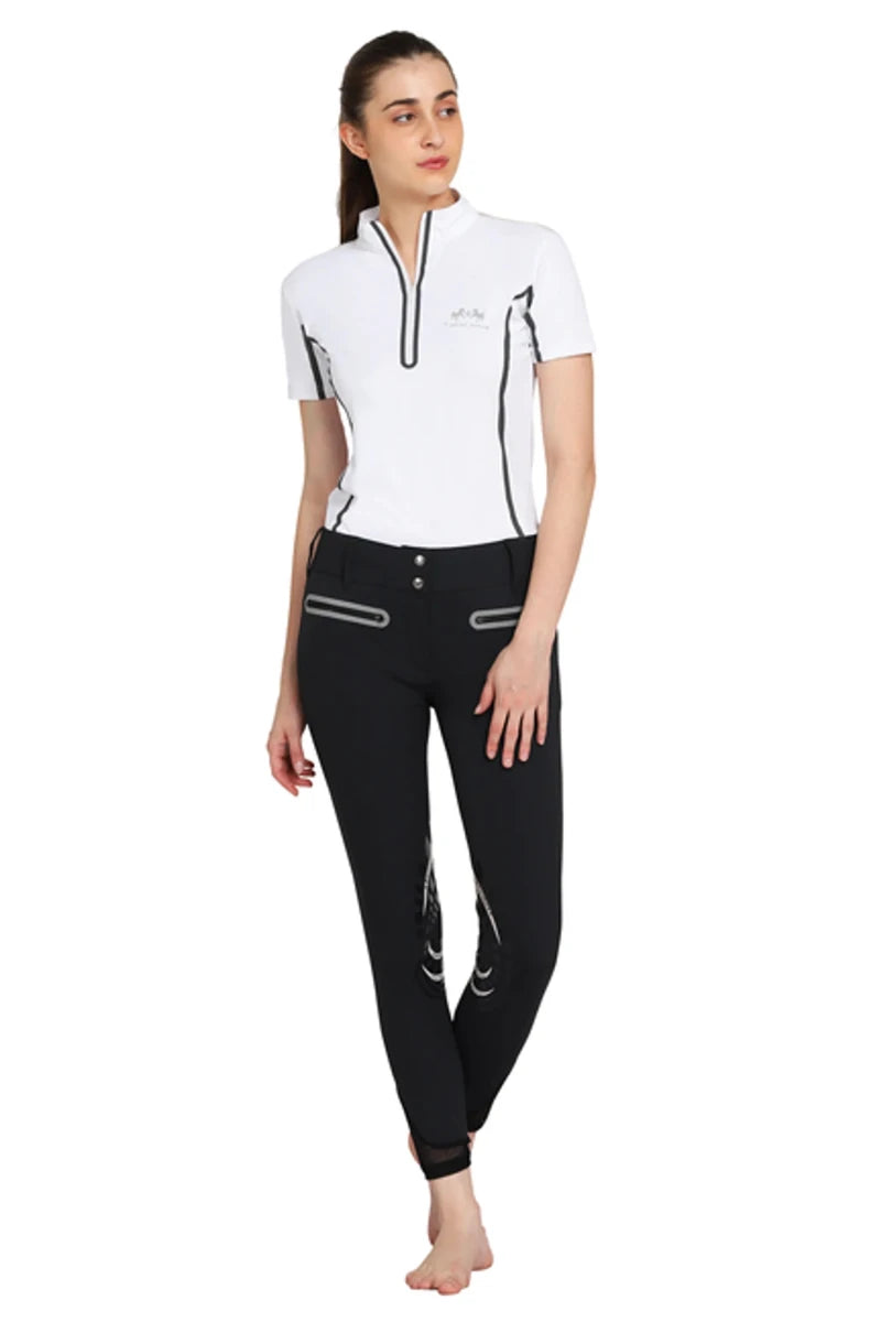 Woman wearing EQUINE COUTURE LADIES IBIZA KNEE PATCH BREECHES with a white short sleeve zip top in equestrian style
