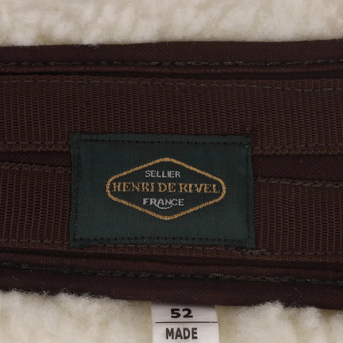 Close-up of Henri de Rivel Equicool Fleece Girth - Moisture Wicking Anatomical Horse Girth with Stainless Steel Hardware label on fleece material