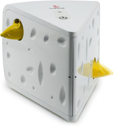 White triangular cat toy with cheese holes and two yellow mice peeking out, seen from an angled perspective.
