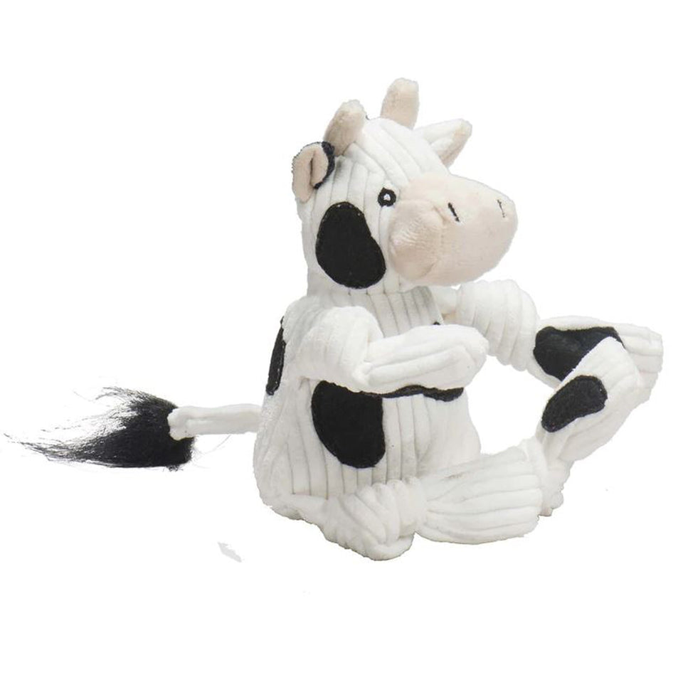 Dottie Cow Knottie plush toy seated in profile showing spotted body and tail