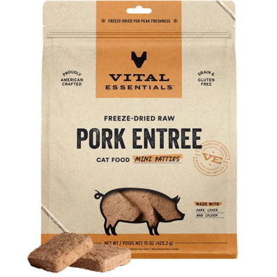 Beige bag of Vital Essentials freeze-dried raw pork cat food with a pig graphic and two mini patties in front.