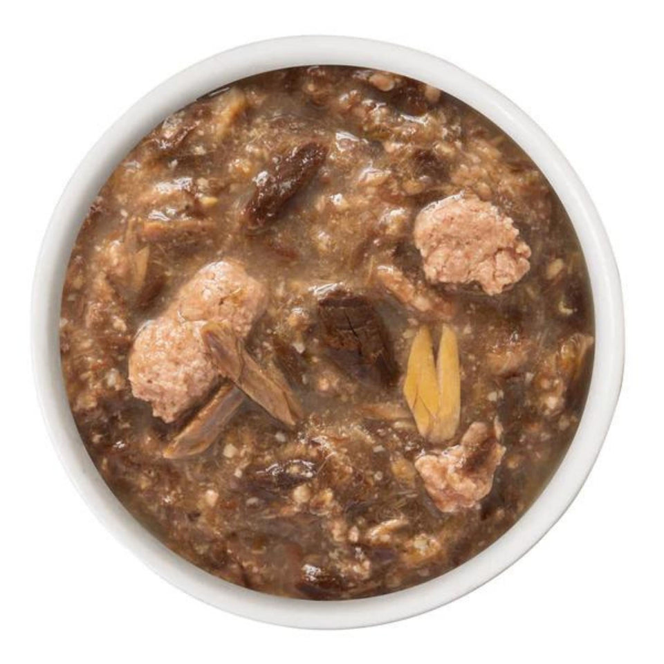 Close-up bowl of Duck and Salmon dinner chunks in gravy