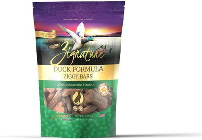 Zignature Duck Formula Ziggy Bars dog treats in a stand-up pouch with a duck flying over a lake at sunset.