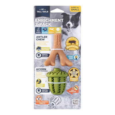 Tall Tails dog enrichment antler chew and acorn treat dispenser in packaging, with a puppy in the background.