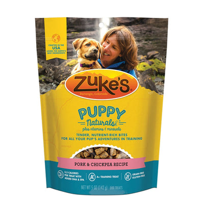 Zuke's Puppy Naturals dog treats in a yellow pouch with a woman and puppy on the front.