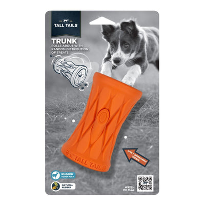 Orange rubber dog toy with a textured surface and a treat-dispensing mechanism, shown in packaging with a black and white.