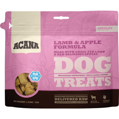 Pink and brown pouch of Acana freeze-dried lamb and apple dog treats, showing the product through a clear window.