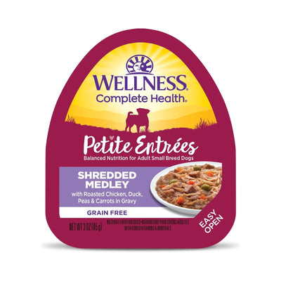 Wellness Complete Health Petite Entrées Shredded Medley dog food in a purple and yellow container, showing a dish of food.