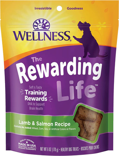 Purple and yellow bag of Wellness Rewarding Life dog treats, Lamb & Salmon recipe, with a window showing treats.