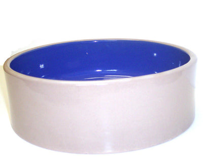 Blue and tan ceramic dog bowl, angled view.