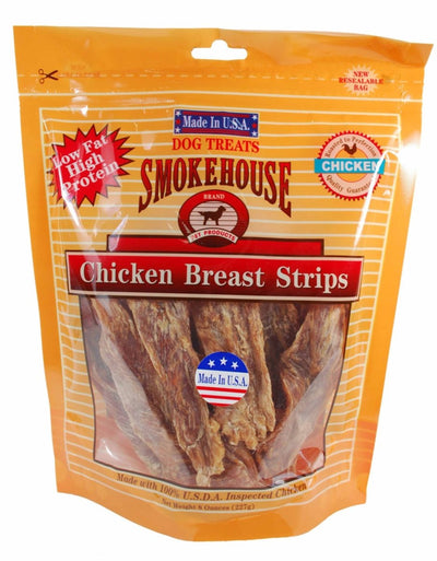 Orange bag of Smokehouse Chicken Breast Strips dog treats with a clear window showing the brown jerky.