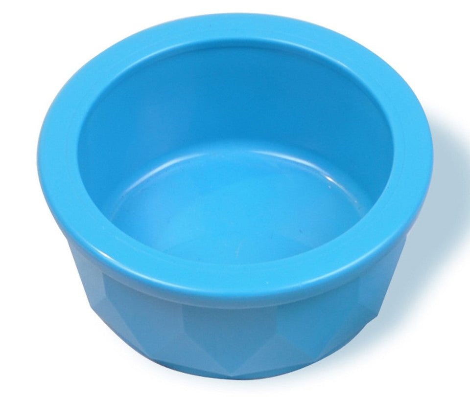 A small, round, translucent blue pet dish with a faceted exterior, casting a shadow on a white background.
