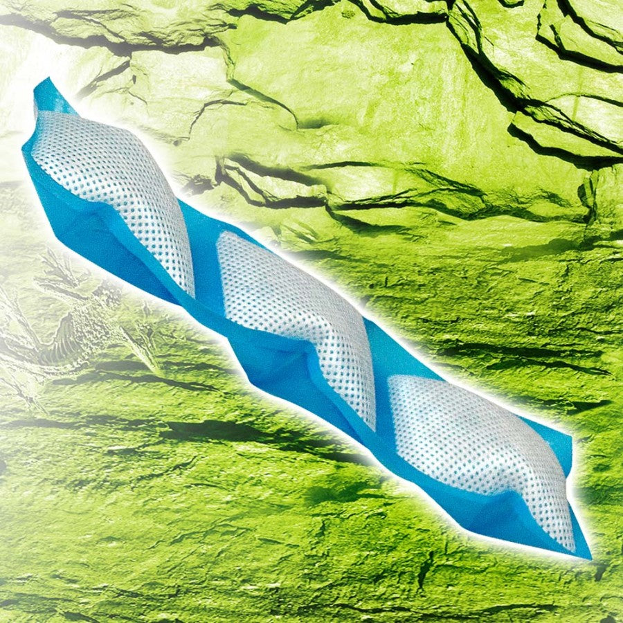 Blue Zilla Water Pillows, a long, segmented mesh tube, lie diagonally on a green, rocky background.