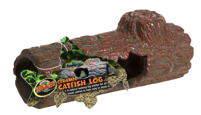 Brown ceramic log aquarium ornament with a product label showing catfish and plants, angled to reveal its hollow interior.