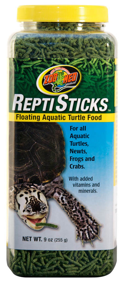 Clear plastic jar of Zoo Med Reptisticks, green floating turtle food, with a yellow lid and a label featuring a turtle.