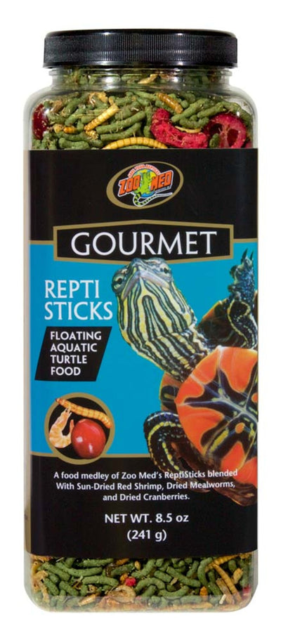 Zoo Med Gourmet Reptisticks turtle food in a clear jar, showing green sticks, mealworms, and cranberries.