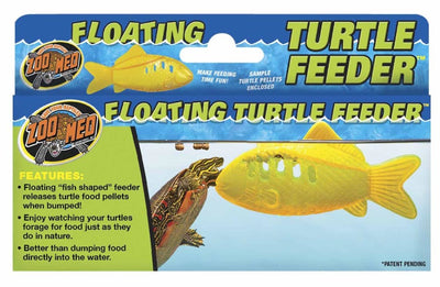 Packaging for a yellow fish-shaped floating turtle feeder, with a turtle interacting with the feeder in water.