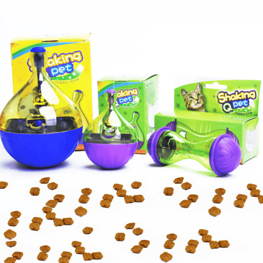 Shaking Q-Pet toy with packaging and scattered treats on a white background