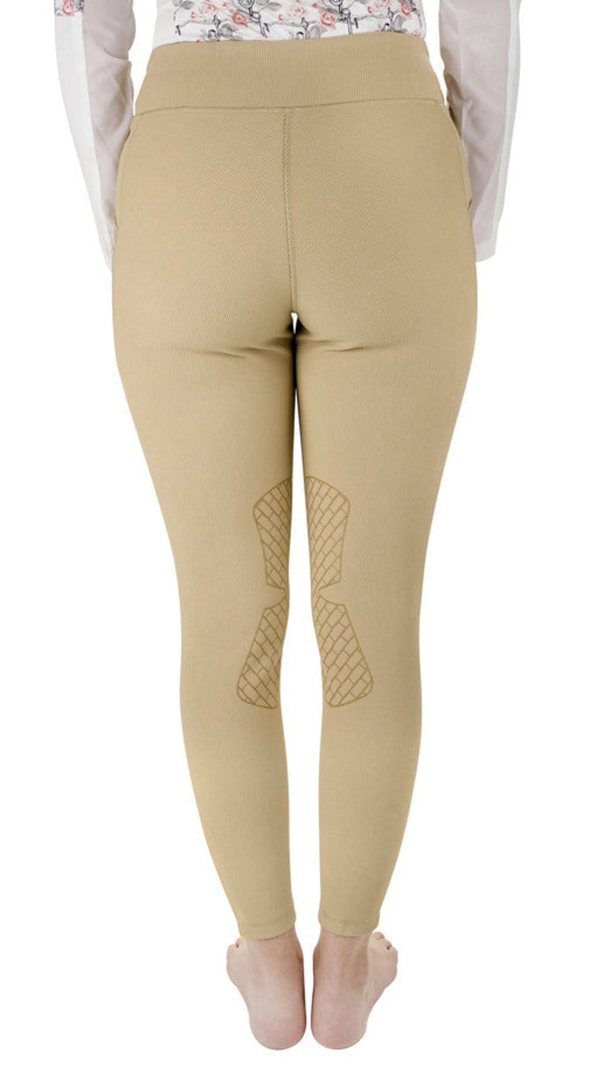 Back view of beige TUFFRIDER LADIES CLASSIC RIBBED TIGHTS worn by a model standing barefoot on white background