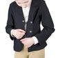 Young rider adjusting black TuffRider Children's EquiVent Show Coat with beige riding pants in studio setting
