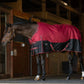 Horse wearing TuffRider Comfy Fit 1200 D RipStop Waterproof/Breathable Comfy Winter Turnout Blanket Medium Weight 200 GSM Standard Neck W/Adjustable Neck - Two Tone Red/Blac in stable aisle