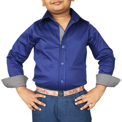 Young boy modeling TuffRider Boys ADEY Shirt-Royal Blue -L with rolled sleeves and patterned belt