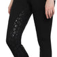 Close-up of a person wearing black TUFFRIDER LADIES MACY WINTER BREECHES with leopard print grip patches on inner legs.