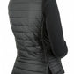Woman wearing a black TuffRider Ladies Combination Reversible Vest with quilted back and side slits, styled for equestrian use.