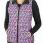 Woman wearing a floral purple TuffRider Ladies Combination Reversible Vest with black collar and pockets