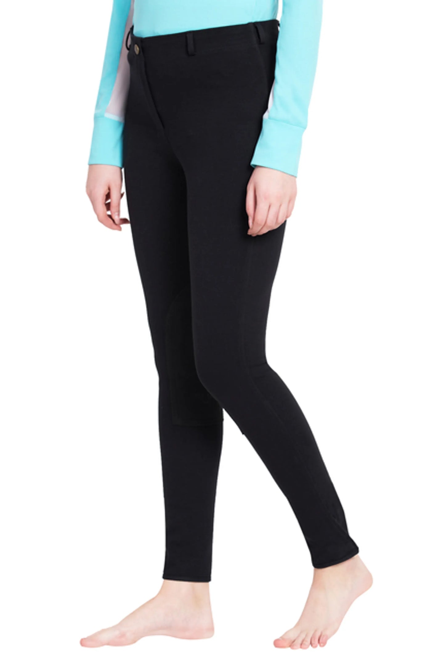 Model wearing black TuffRider Ladies Cotton Pull-On Knee Patch Plus Breeches with a light blue long sleeve top