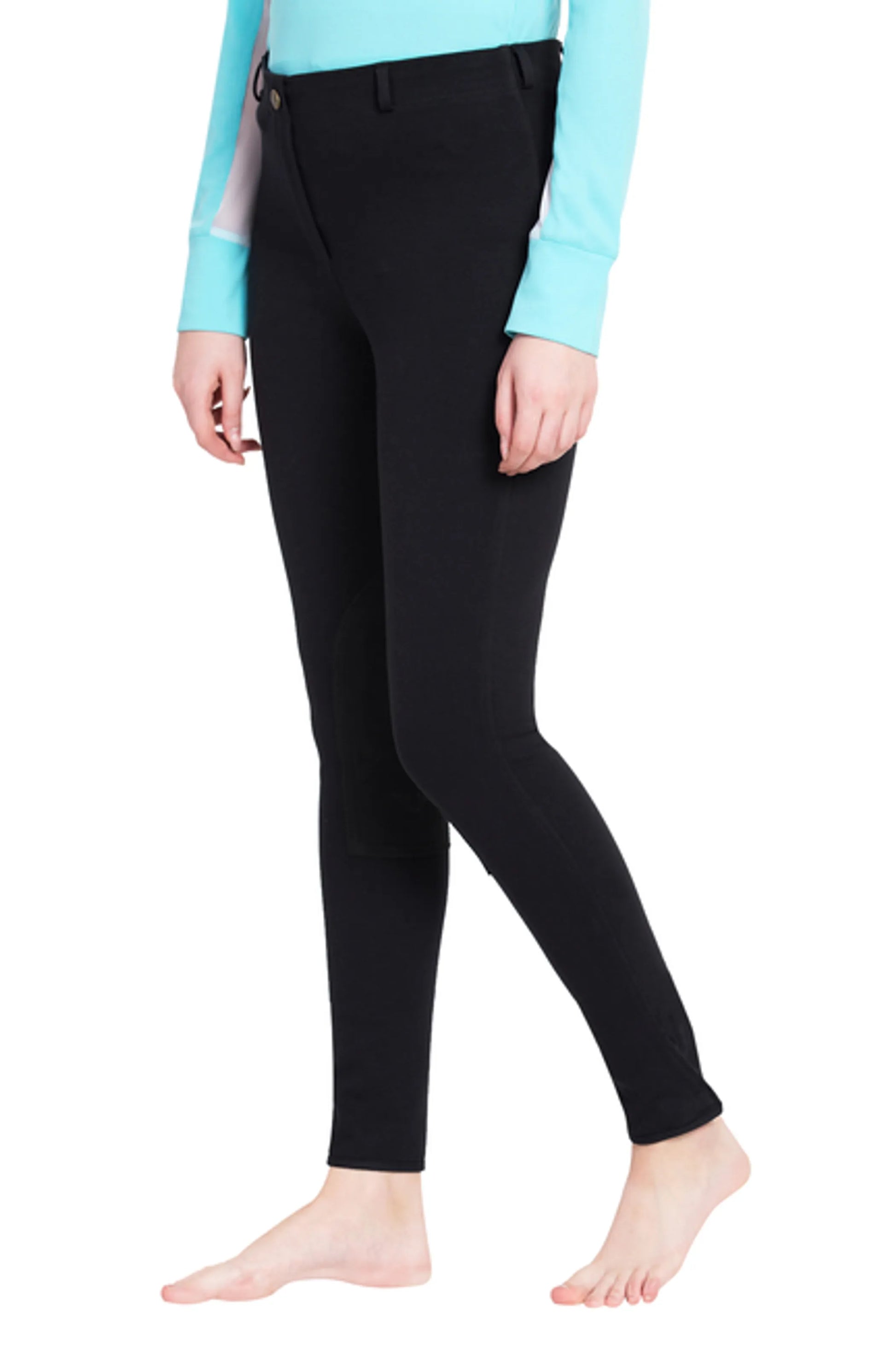 Model wearing black TuffRider Ladies Cotton Pull-On Knee Patch Plus Breeches with a light blue long sleeve top
