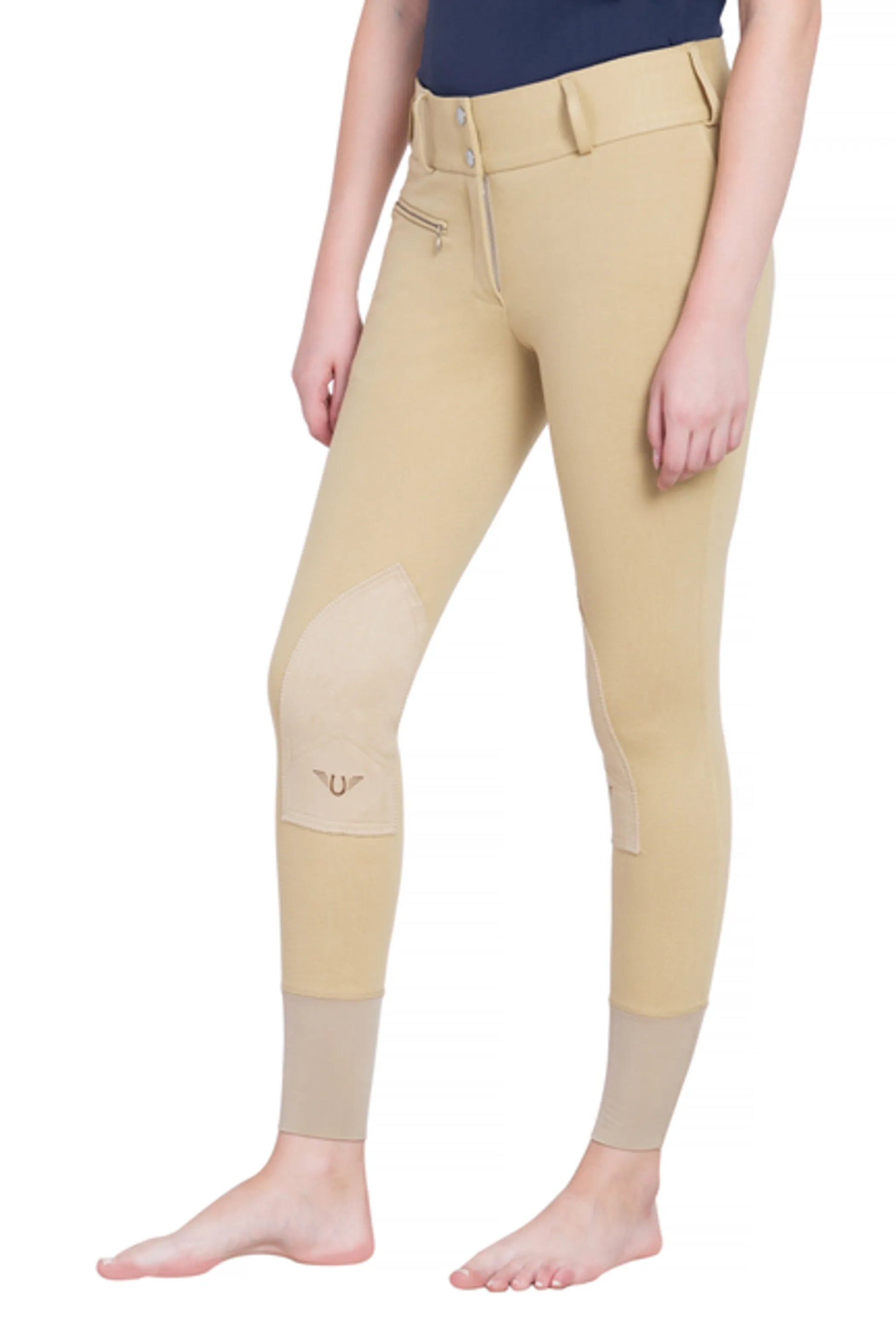 Woman wearing TuffRider Ladies Cotton Lowrise Wide Waistband Knee Patch Breeches in beige standing barefoot