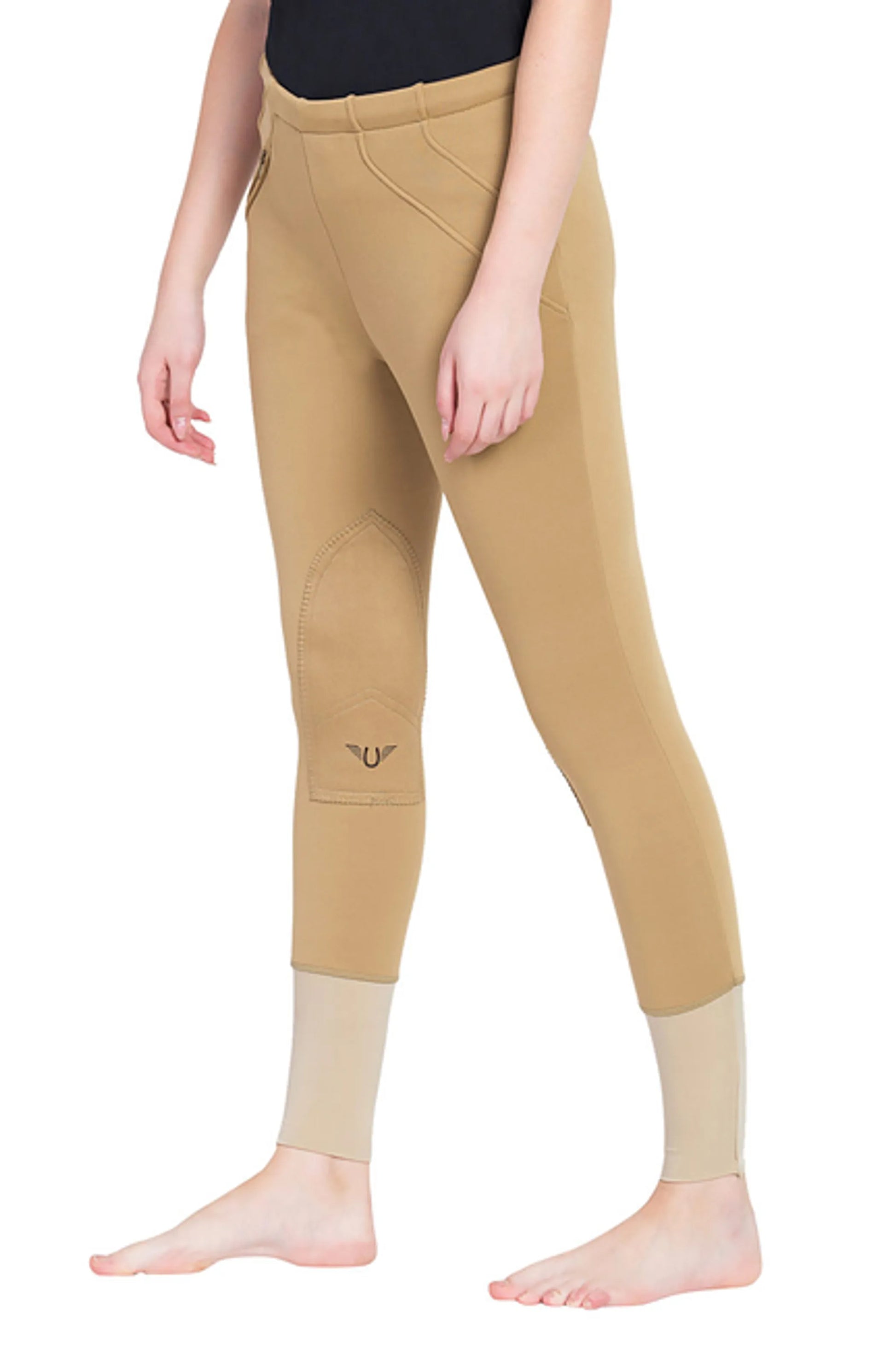 Woman wearing tan TuffRider Ladies Unifleece Pull-On Winter Breeches with full seat grip, modeling equestrian apparel.