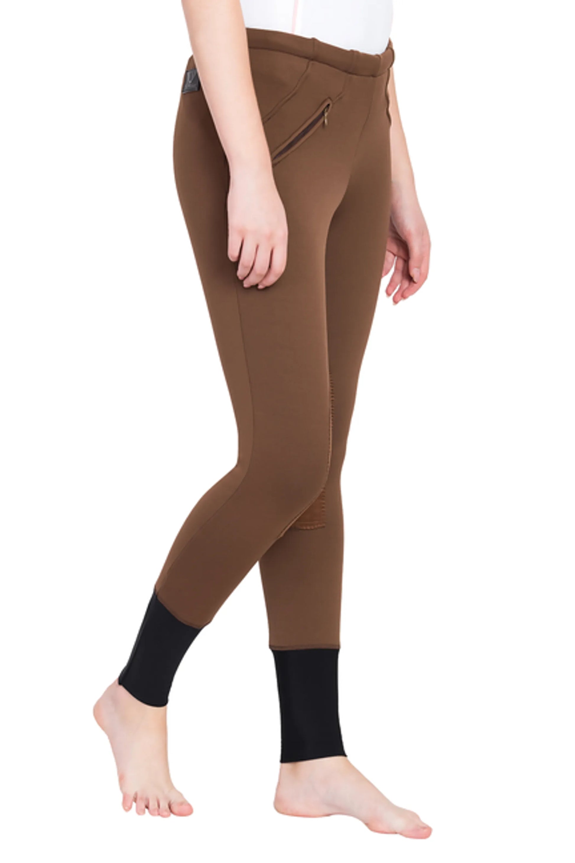 Model wearing TuffRider Ladies Unifleece Pull-On Winter Breeches in brown with black ankle panels.