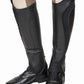 Black leather TuffRider Ladies Derby Leather Half Chaps worn over tan riding pants with black riding boots.