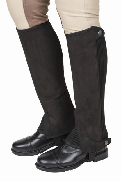 Tuffrider Ladies Saratoga Synthetic Half Chaps in black synthetic material worn over riding boots on beige breeches