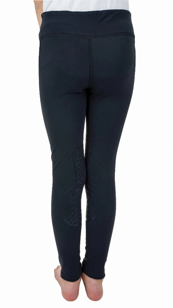 Rear view of a child wearing TuffRider Kids Minerva 3 Season Printed Knee Patch Tights in black with textured knee patches