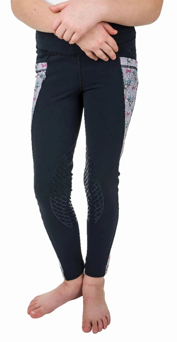 Child wearing black leggings with floral side panels and knee patches, TuffRider Kids Minerva 3 Season Printed Knee Patch Tights