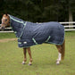Horse standing in grass wearing a navy blue TUFFRIDER KOZY KOMFORT COMBO STABLE BLANKET- NAVY, 69 outdoors