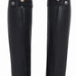 Black equestrian leg covers with zippers and straps on beige riding pants, TuffRider Ladies Gaiters