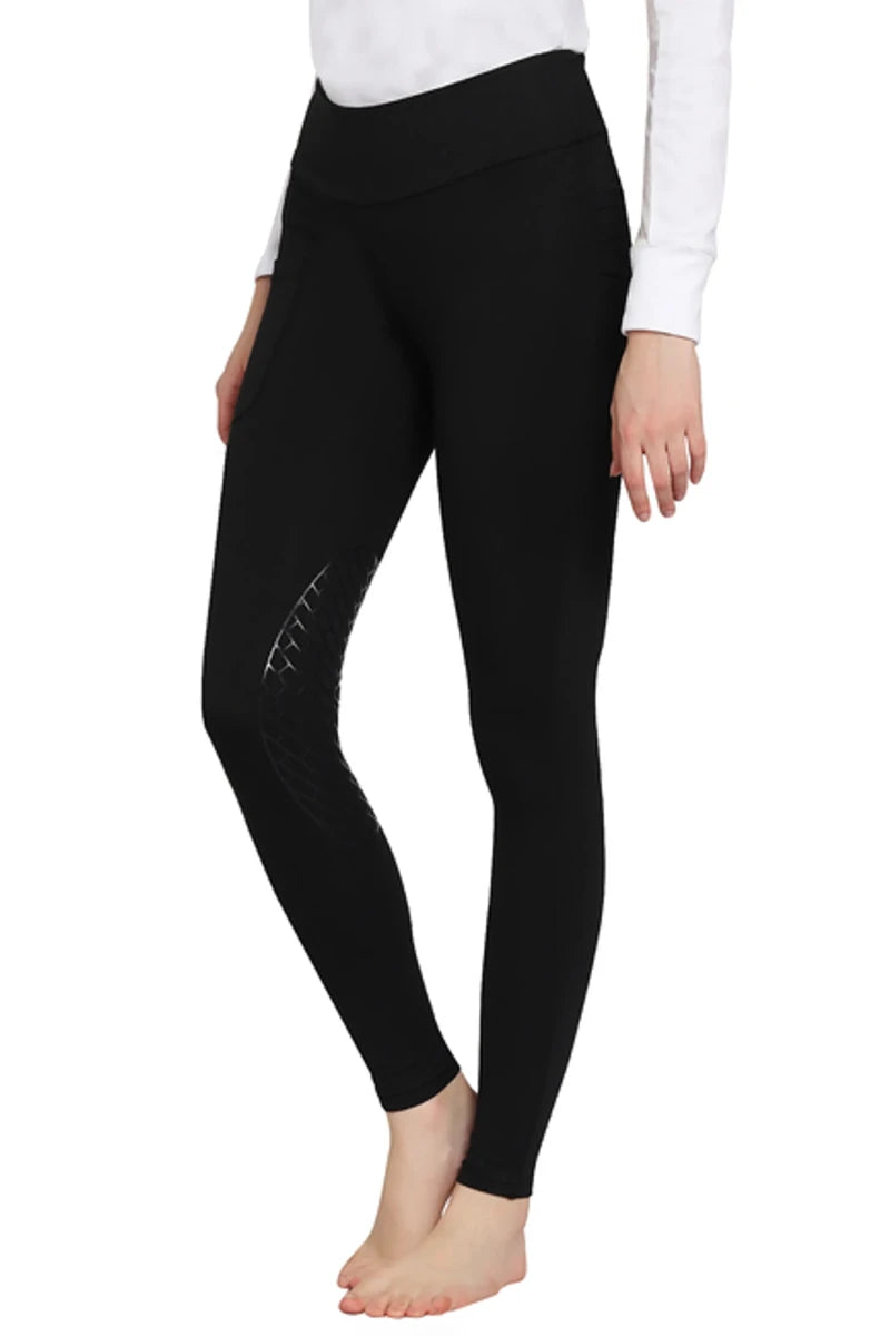 TuffRider Ladies Bootie Tights With Pocket in black, showing textured knee detail on a model wearing a white top
