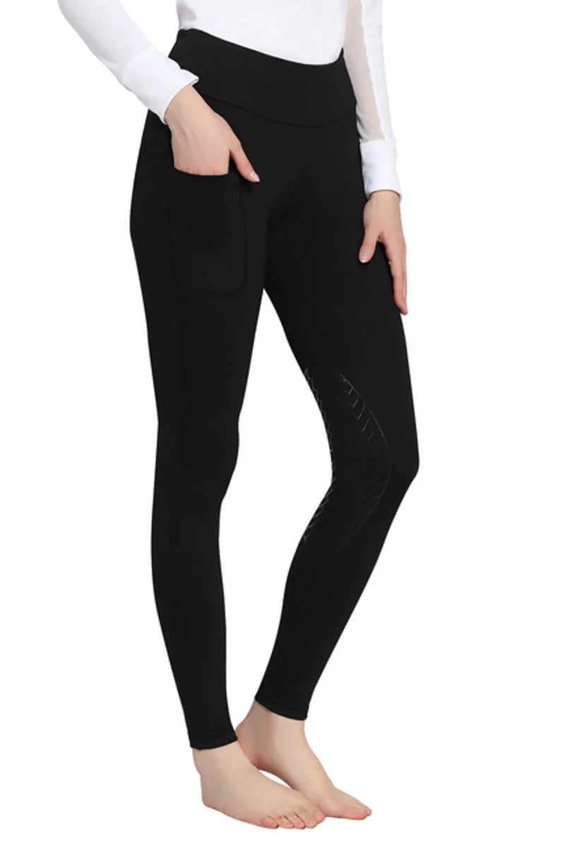 Woman wearing black TuffRider Ladies Bootie Tights With Pocket standing barefoot with hand in pocket