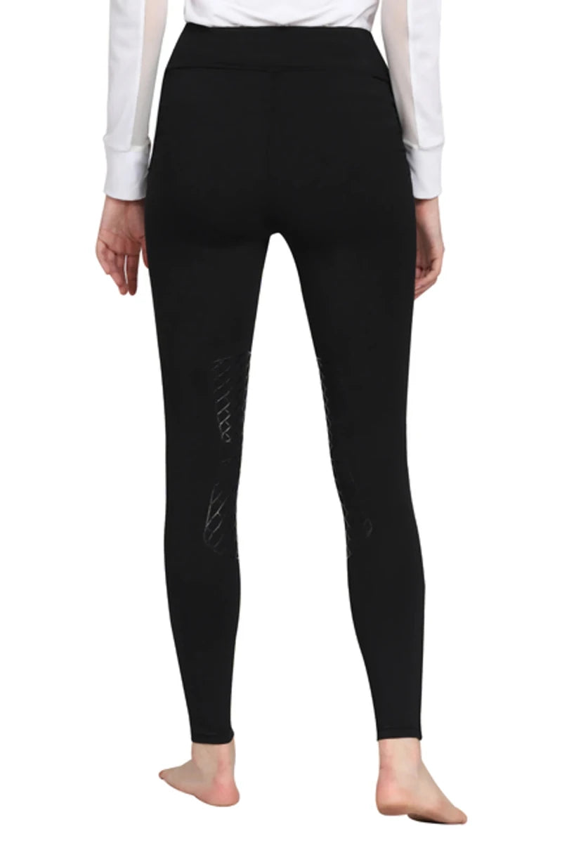 Rear view of person wearing black TuffRider Ladies Bootie Tights With Pocket, showing full leg coverage and ankle length design.