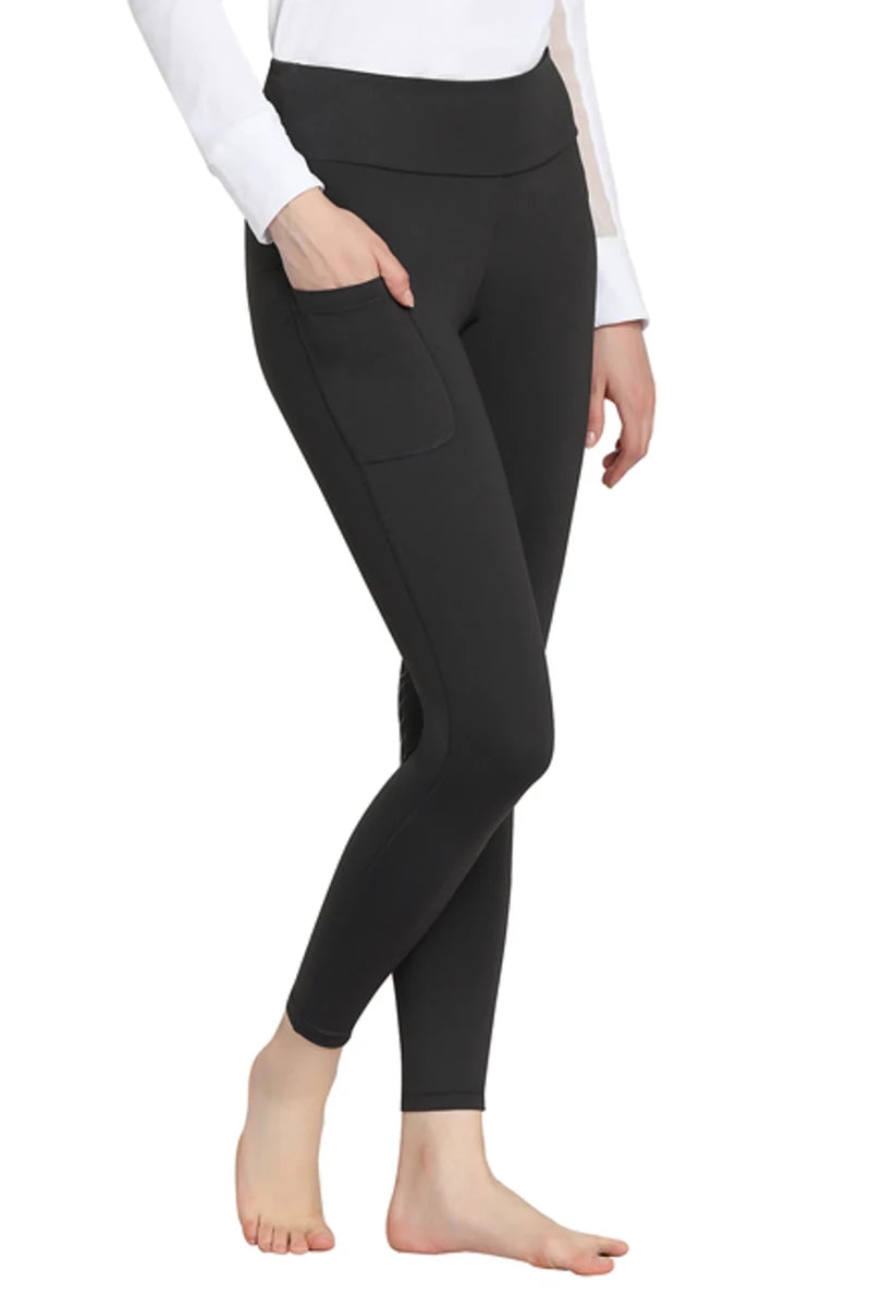 Woman wearing black TuffRider Ladies Bootie Tights With Pocket with hand in side pocket standing barefoot