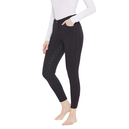 Woman wearing black EQUINE COUTURE HEATHER FULL SEAT BREECH with patterned grip patches on inner legs.